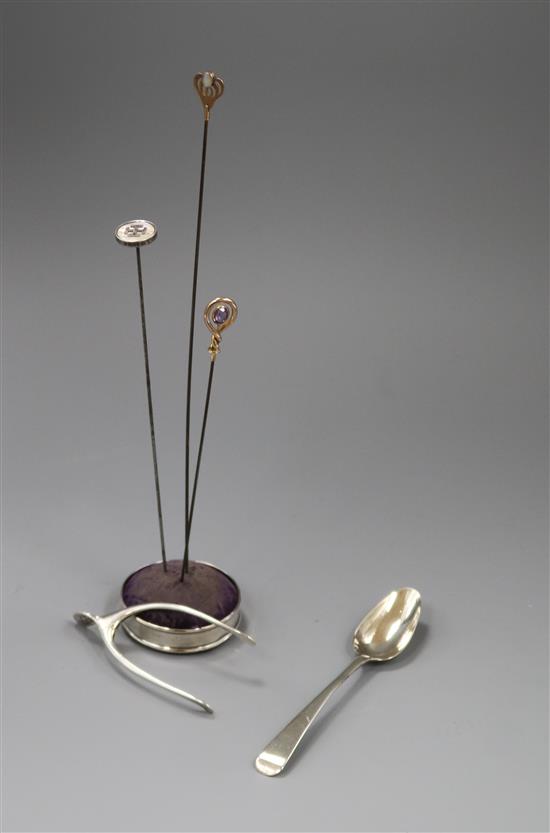 Three hat pins, a silver mounted hatpin holder, pair of silver wishbone sugar nips and a silver teaspoon.